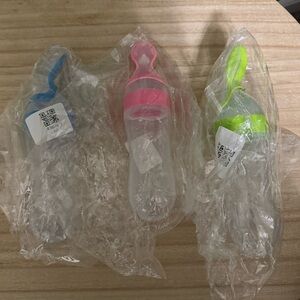 Set of Three Baby Feeding Bottles with Pink, Blue, and Green Accents